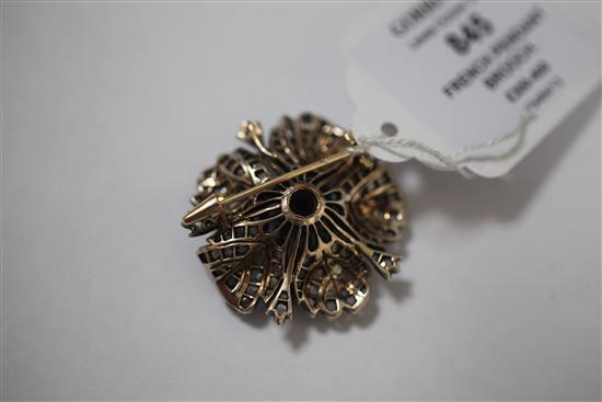 A late 19th/early 20th century French 18ct gold and silver, garnet and rose cut diamond set pendant brooch, 1.5in.